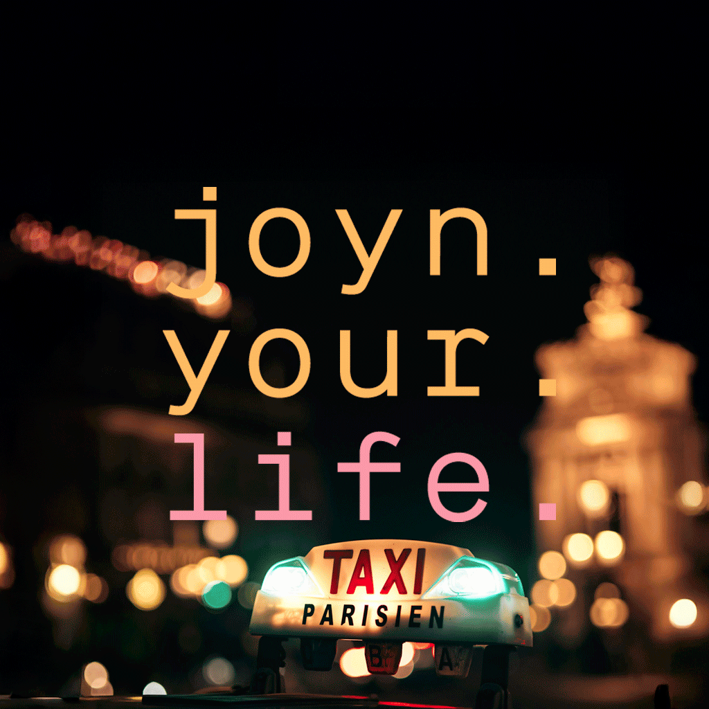 Ein leuchtendes Taxischild mit der Aufschrift TAXI PARISIEN bei Nacht und den Lichtern der Stadt im Hintergrund. Überlagert Text sagt joyn. Ihr. Leben. in großen Pastell Buchstaben.