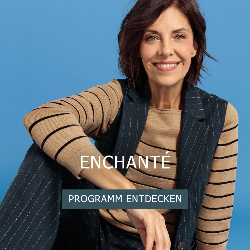 Eine lächelnde Frau mit kinnlangen braunen Haaren trägt ein beige-schwarz gestreiftes Oberteil unter einer marineblauen Nadelstreifenweste und -hose und sitzt vor einem blauen Hintergrund. Der Text lautet ENCHANTÉ und PROGRAMM ENTDECKEN.